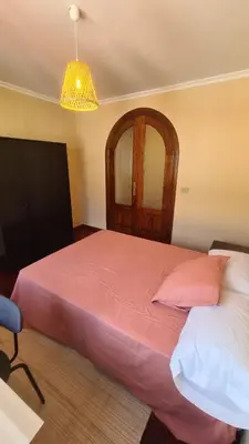 a bedroom with a large bed with a pink blanket at Montirón Lucus Confort in Lugo