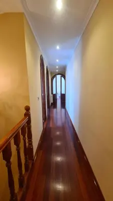 a hallway of a house with wooden floors and a staircase at Montirón Lucus Confort in Lugo
