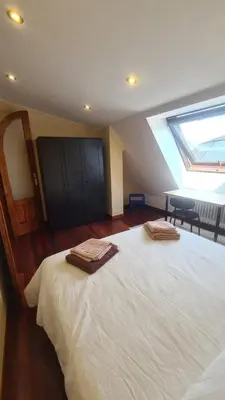 a bedroom with a bed with two towels on it at Montirón Lucus Confort in Lugo