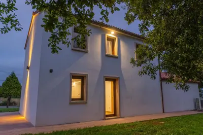 a white house with two windows on the side of it at Casa Tía Pepa in Castenda