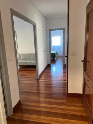 an empty living room with a couch and a mirror at Viviendas vacacionales as lagas in Palas de Rei