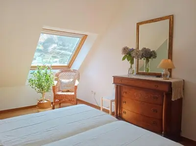a bedroom with a mirror on top of a dresser at Penthouse Panorámico in Viveiro