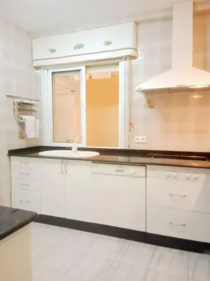a white kitchen with a sink and a mirror at Pastor Diaz Home in Viveiro