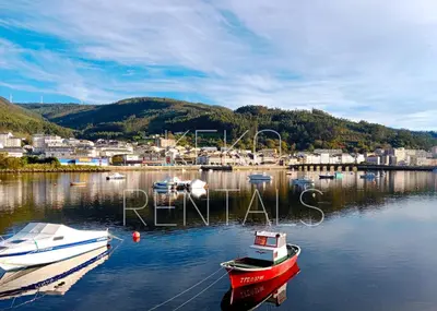 a group of boats are docked in a harbor at Pastor Diaz Home in Viveiro