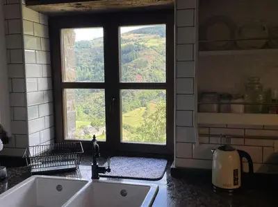 a kitchen with a sink and a large window at Casona Rural de Lujo con increíbles vistas, La Casa de Rafael, ahora con 4 habitaciones in San Antolín