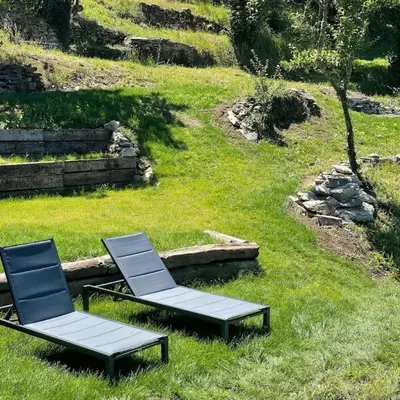two chairs sitting in the grass in a field at Casona Rural de Lujo con increíbles vistas, La Casa de Rafael, ahora con 4 habitaciones in San Antolín