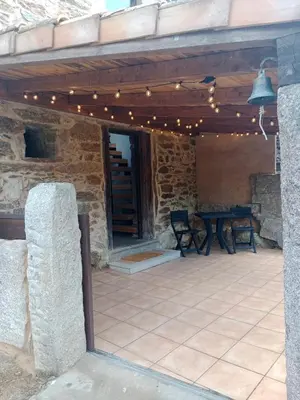 a patio with a table and lights on it at La Gavina in Beáriz