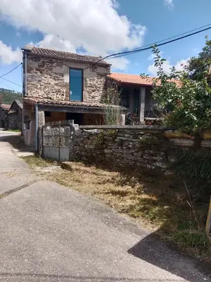 a stone house on the side of a road at La Gavina in Beáriz