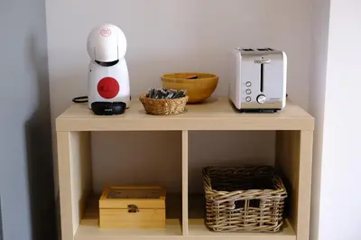 a small wooden table with a blender and a toaster at Adarve, con parking y vistas a la muralla in Lugo