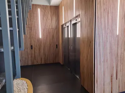 a hallway with a elevator with wooden walls at Adarve, con parking y vistas a la muralla in Lugo