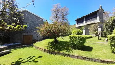 a house with a yard with grass and a building at Casa rural con piscina en la Ribeira Sacra. in Campos