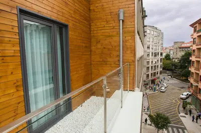 a balcony with a wooden wall and a city street at Hotel Lux Santiago in Santiago de Compostela