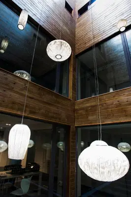 three lights hanging from the ceiling of a building at Hotel Lux Santiago in Santiago de Compostela