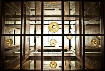 a view through a window of a building with clocks at Hotel Lux Santiago in Santiago de Compostela