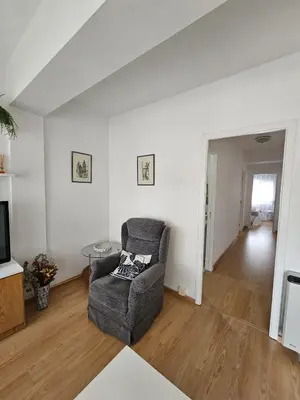 a living room with a chair and a television at MEDA Padrón in Padrón