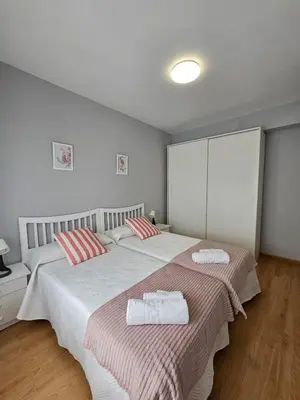 a bedroom with two beds with towels on them at MEDA Padrón in Padrón
