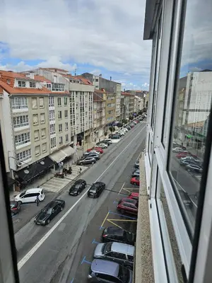 a view from a window of a city street with cars at MEDA Padrón in Padrón
