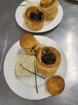 two plates of pastries and rice on a table at COMPLEXO TURISTICO PONTE MOURULLE in Insúa