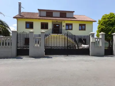 a house with a gate in front of it at A Casa dos Vellos in Santa Irene