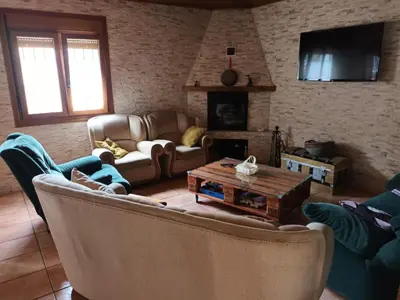 a living room with a couch and a table at A Casa dos Vellos in Santa Irene
