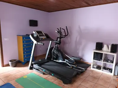 a room with a gym with a treadmill at A Casa dos Vellos in Santa Irene