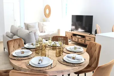 a dining room table with plates and glasses on it at Casa da Americana I in Boqueijón