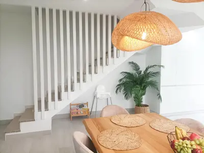 a dining room with a wooden table and chairs at Casa da Americana II in Boqueijón