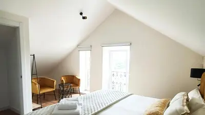 a bedroom with a bed and a table and chairs at Casa da Americana II in Boqueijón