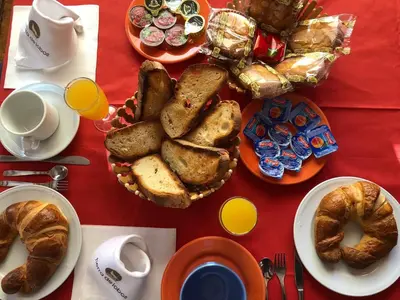 a table with bread and pastries and a cup of coffee at Tierra De Lobos in Puebla de Sanabria