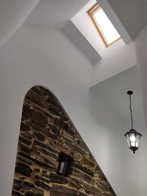 a room with a brick wall and a light fixture at Lazzaretto vivienda uso turístico in Lugo