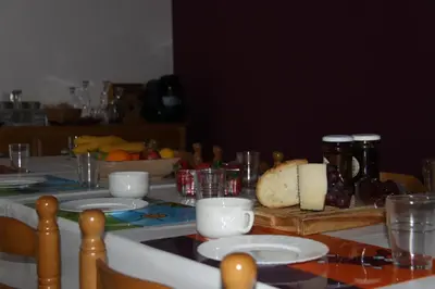 a table with a white table cloth with bread on it at Venecia Bed&Breakfast in Villafranca del Bierzo