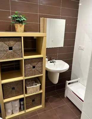 a bathroom with a sink and a toilet and a mirror at Arnela Reinante in Barreiros