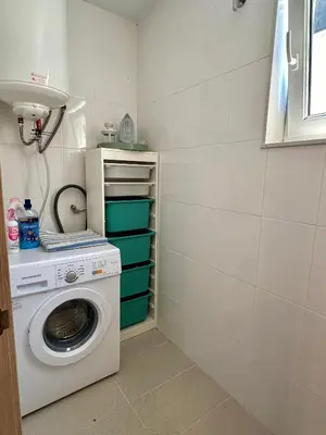 a laundry room with a washer and a washing machine at Arnela Reinante in Barreiros