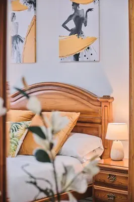 a bedroom with a bed and a table with a lamp at Peregrina Pensión 6 in O Pedrouzo