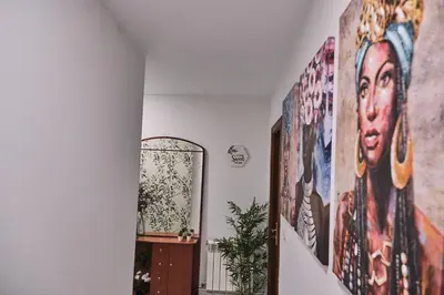 a hallway with posters offamousfamous people on the walls at Peregrina Pensión 6 in O Pedrouzo