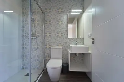 a bathroom with a toilet and a sink and a shower at Apartamentos Carballal in Palas de Rei