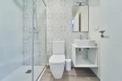 a bathroom with a toilet and a sink and a shower at Apartamentos Carballal in Palas de Rei