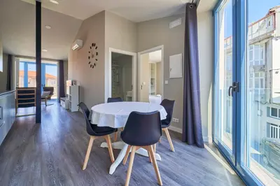 a kitchen and dining room with a table and chairs at Apartamentos Carballal in Palas de Rei