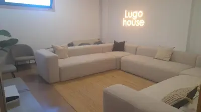 a living room with a white couch and a table at Micampus Lugo Student Residence in Lugo