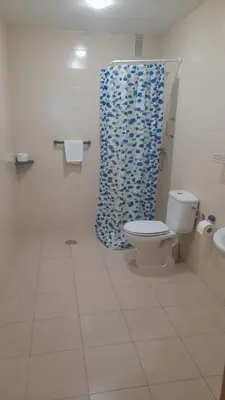 a bathroom with a toilet and a shower curtain at Micampus Lugo Student Residence in Lugo