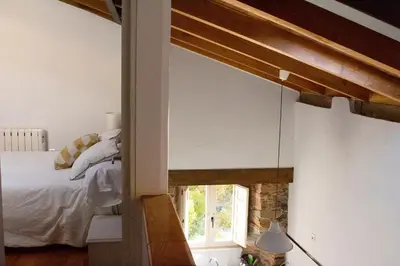 a bedroom with a bed and a window at Casa de las Flores / Casa de campo LUGO in A Pontenova