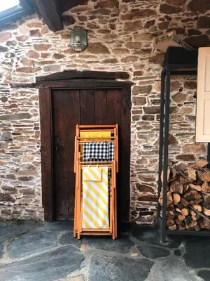 a wooden door in front of a brick building at Casa de las Flores / Casa de campo LUGO in A Pontenova