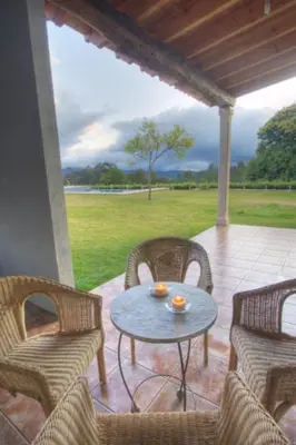 a patio with a table and chairs on a porch at A Casa da Tulla in Gomesende