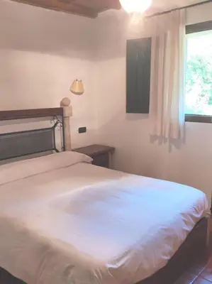 a bedroom with a white bed and a window at Casa Vilanova in A Coruña