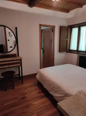 a bedroom with a bed and a mirror and a piano at Casa Vilanova in A Coruña