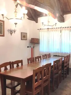 a dining room with a large wooden table and chairs at Casa Vilanova in A Coruña
