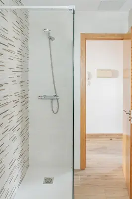 a shower with a glass door in a bathroom at Piso en el puerto con vistas al Mar+Wifi+ SmartTv in Burela de Cabo