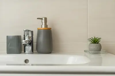 a bathroom counter with a sink with a soap dispenser at Piso en el puerto con vistas al Mar+Wifi+ SmartTv in Burela de Cabo