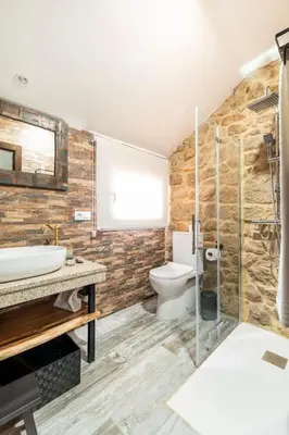 a bathroom with a toilet and a sink at Casa Rústica O Abeiro in Pontevedra