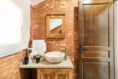 a bathroom with a bowl sink and a mirror at Casa Rústica O Abeiro in Pontevedra